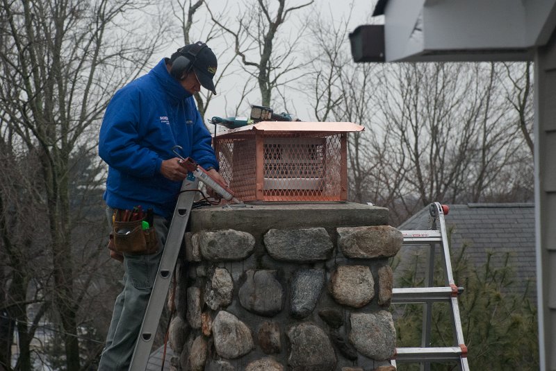 DSC_9114.jpg - Everything gets a bead of caulk and is screwed down.