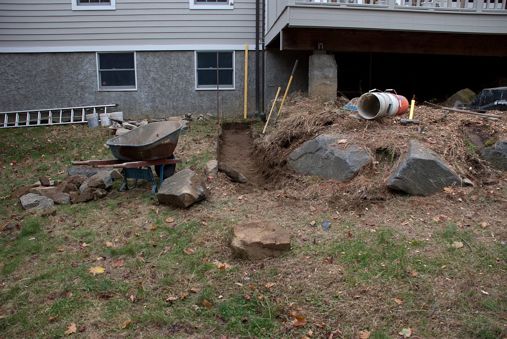 DSC_8267.jpg - Harold the mason prepares a base for the new wall that will go here.