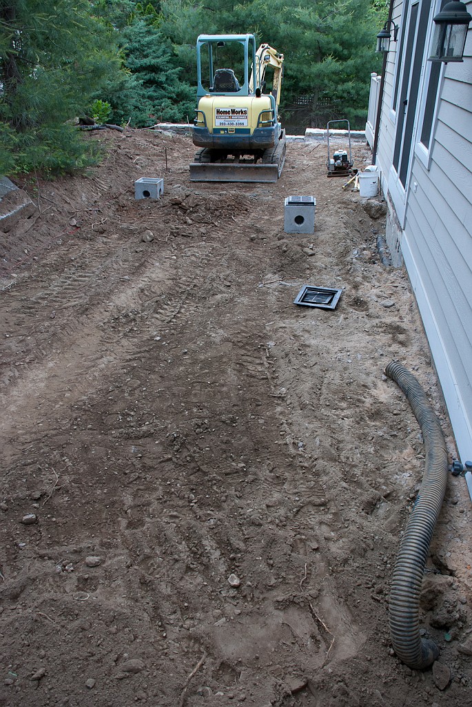 DSC_8570.jpg - The old drain pipes are exposed.  These sent east roof runoff to an outlet under the deck.  A bad idea that caused problems.