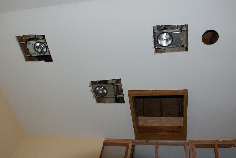 DSC_9591.jpg - The electricians were more than generous with the size of the cut outs made for the lights.  I would have cut 6-inch diameter circles, like the original one on the right, and aligned the housings from above.